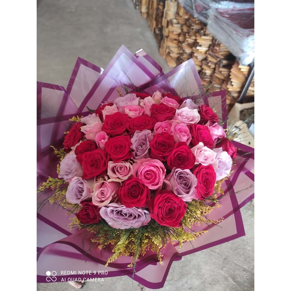 Bouquet of Colorful Roses with fresh greens.